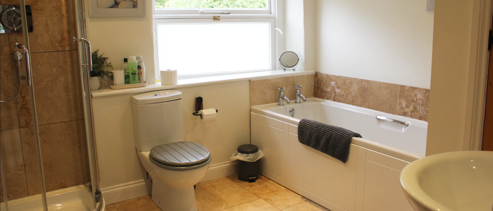 Bathroom interior with bath and shower at Kibble Cottage