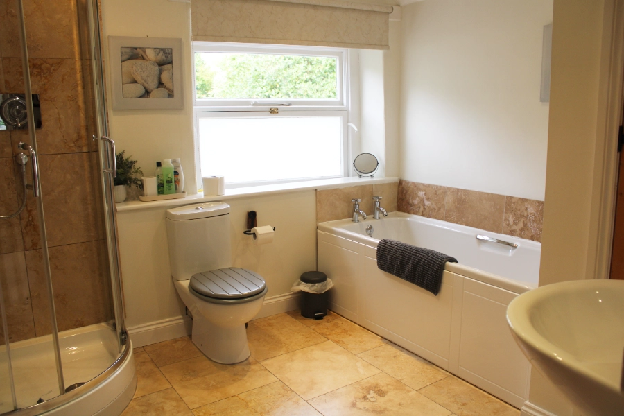 Bathroom with bath and separate shower at Kibble Cottage