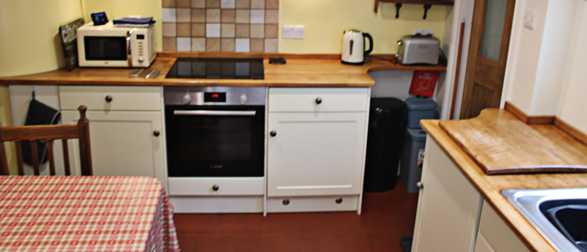 Kitchen with oven and hob at Kibble Cottage