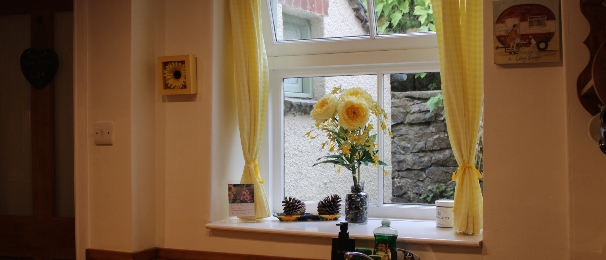 Kitchen window with flowers at Kibble Cottage