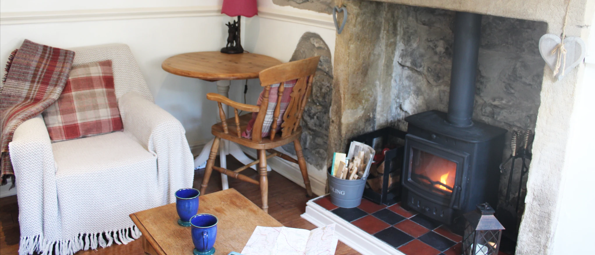 Lounge seating and wood burner at Kibble Cottage