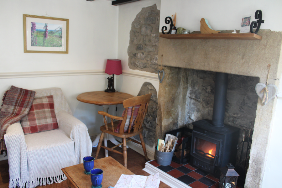 Cosy lounge with wood burner at Kibble Cottage